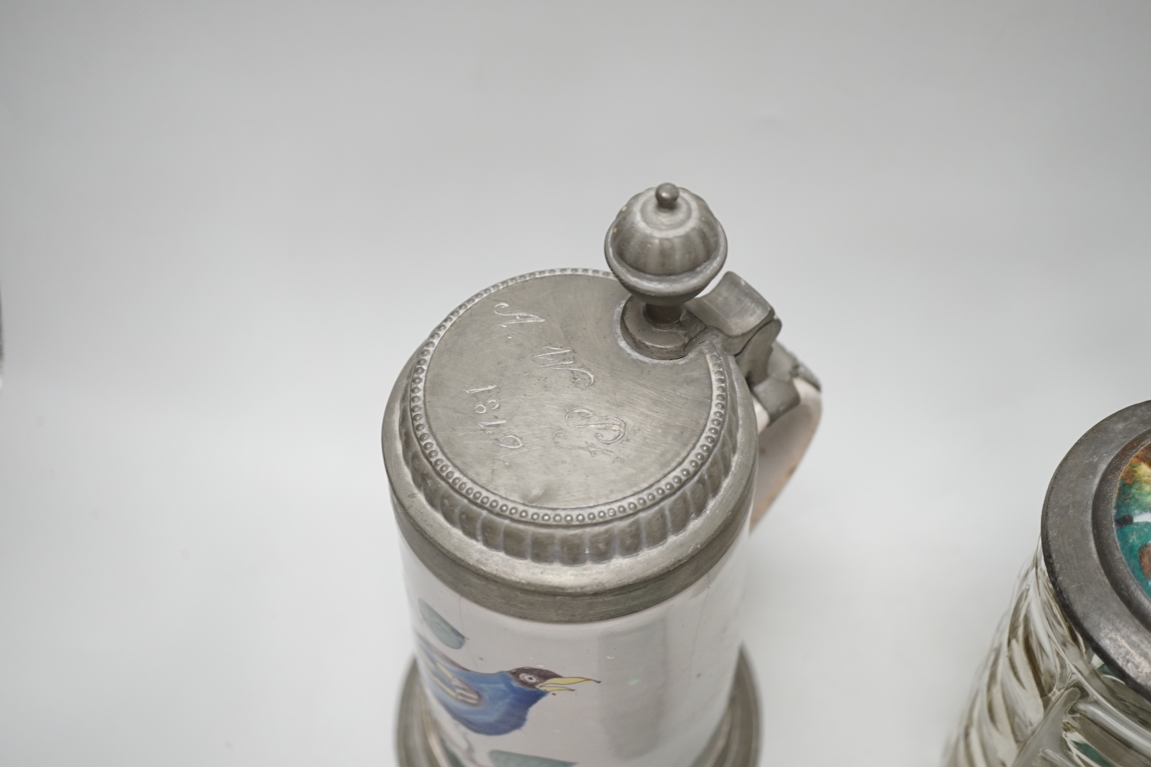 A German faience stein, dated 1819, a glass stein and an inkwell, largest 24cm